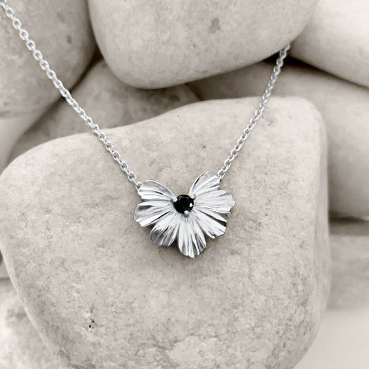 Silver floral heart shaped pendant with black moissanite on a rolo chain