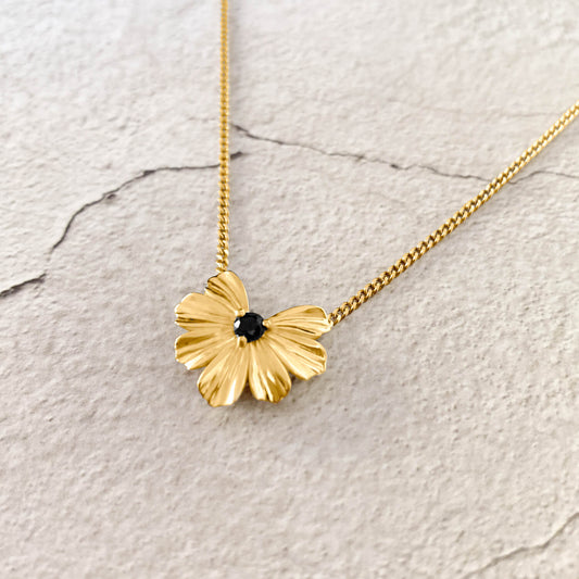Floral Heart pendant in 9k yellow gold with black moissanite on a curb chain.