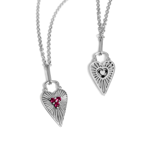 Front and back view of the Sunburst Heart Pendant set with rhodolite on a rolo chain.