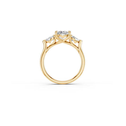 Side view of three-stone ring showing flowing design detail in yellow gold