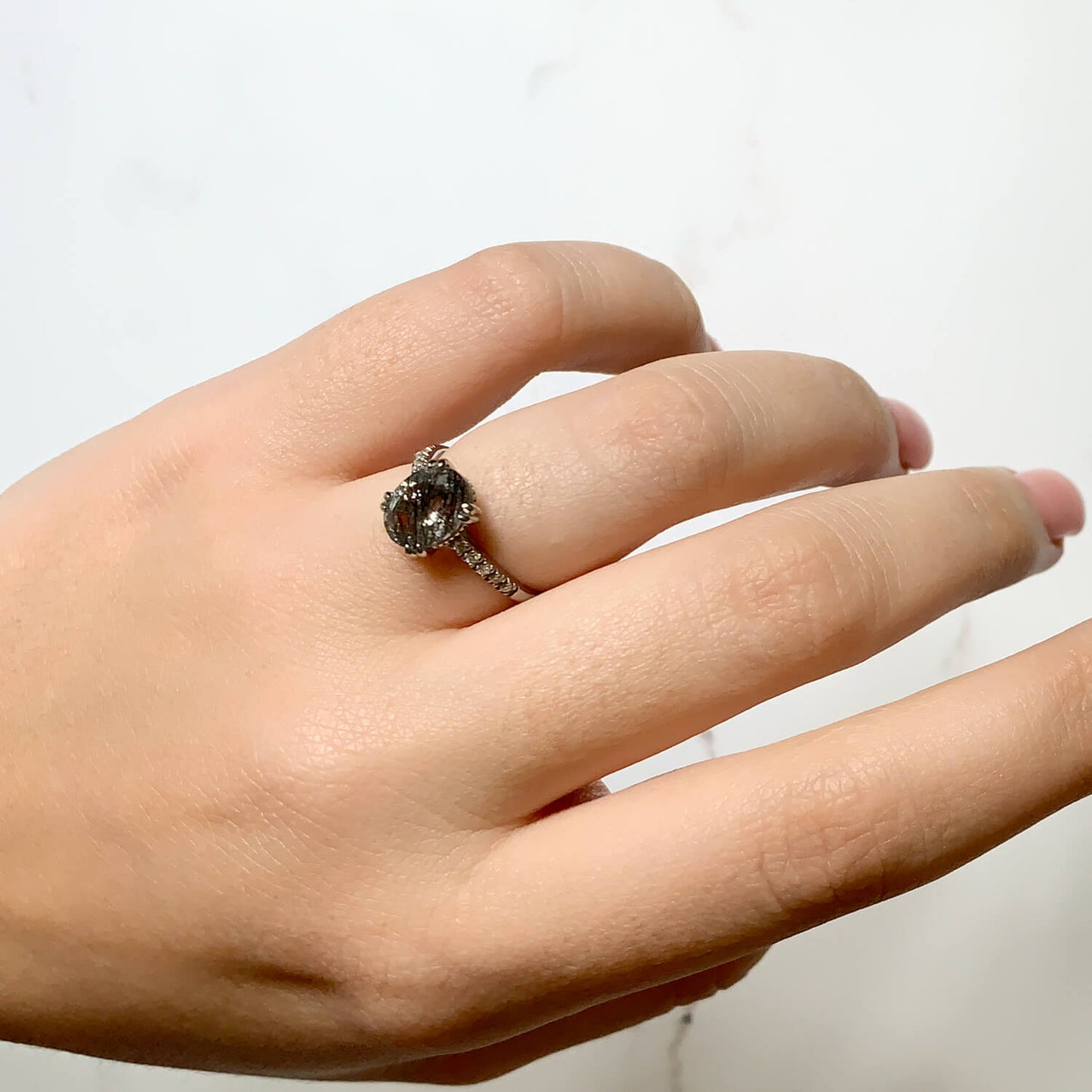 9k White gold rutile quarts and moissanite solitaire ring on hand