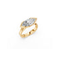 Perspective view of dramatic marquise diamond ring with modern silhouette and east-west partial bezel in yellow gold