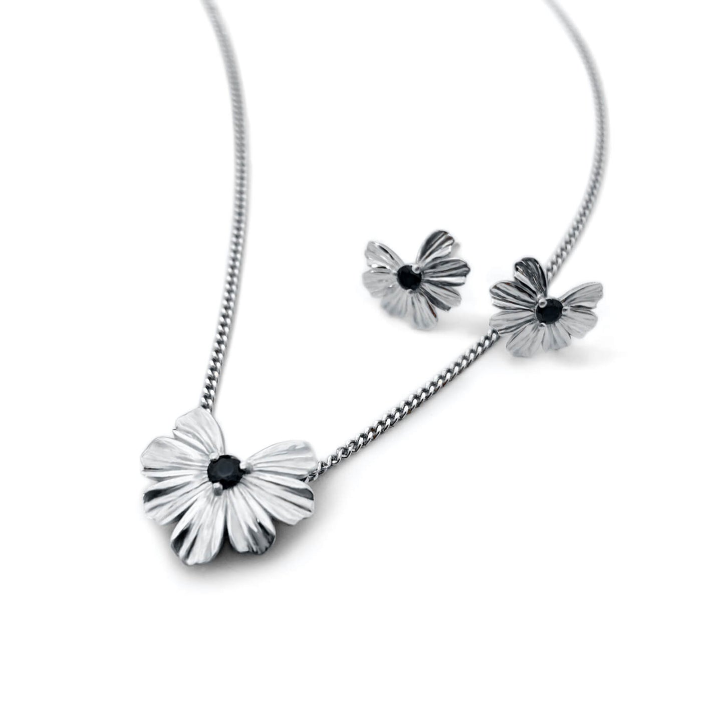 Silver floral heart shaped pendant and earrings with black moissanite 