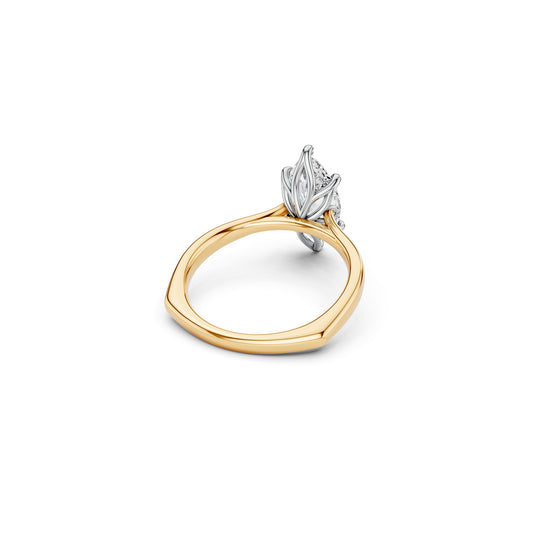 Two-tone marquise solitaire ring with a white gold petal-inspired setting on a yellow gold euro shank with cathedral shoulders