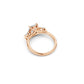 Angled side view of three stone engagement ring showing design detail in rose gold 