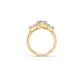 Side view of three-stone ring showing flowing design detail in yellow gold
